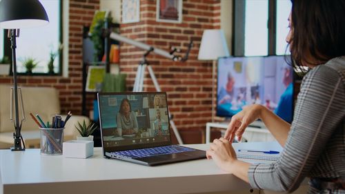 Midsection of woman using laptop at office