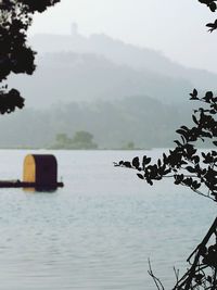 Scenic view of lake during foggy weather