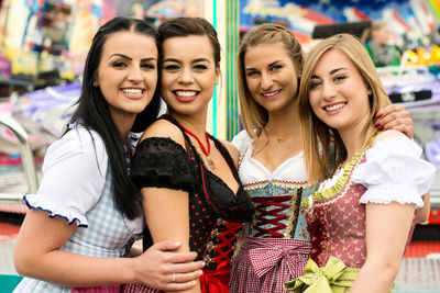 Portrait of happy friends at amusement park during oktoberfest