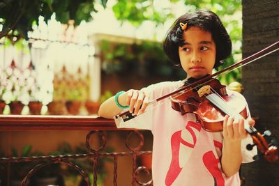 Portrait of a girl holding and playing violin