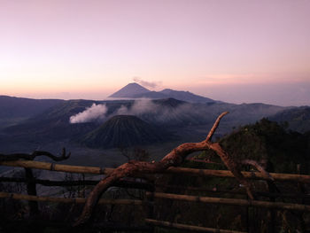 Scenic view of volcanic mountain against sky during sunset