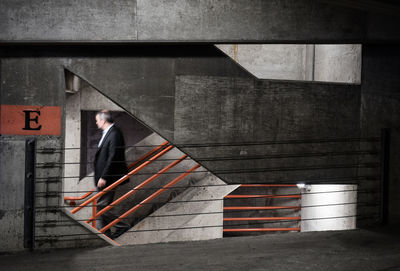 Side view of businessman moving down steps of building