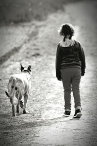 Woman with dog walking on zebra crossing