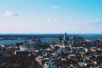 View of cityscape against cloudy sky