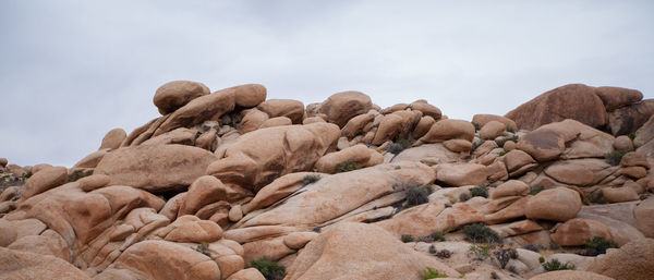 Low angle view of rock formation against sky