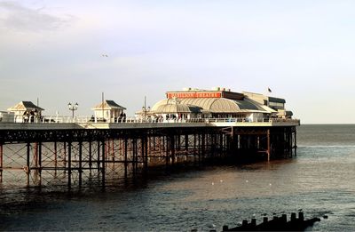 Cromer pier over sea against sky