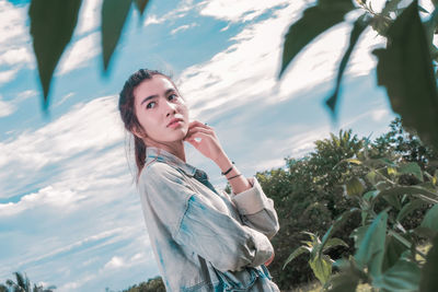 Portrait of woman standing against plants