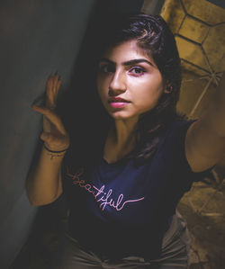 Portrait of beautiful young woman sitting at home