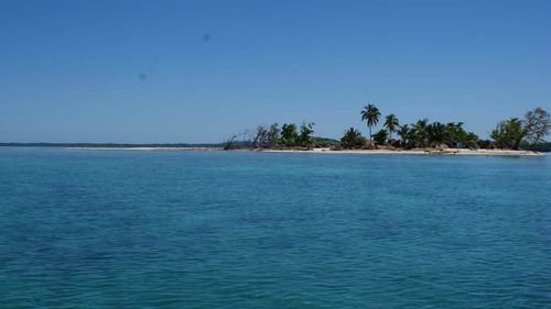 Scenic view of sea against clear blue sky