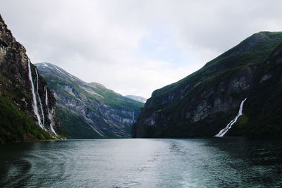 Scenic view of river amidst mountains against sky