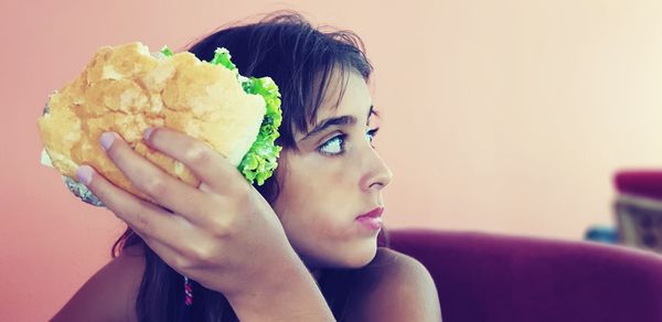 Close-up portrait of a young woman holding ice cream
