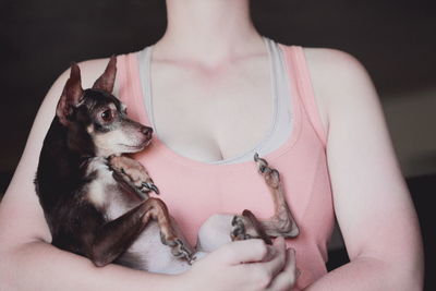 Young woman holding dog