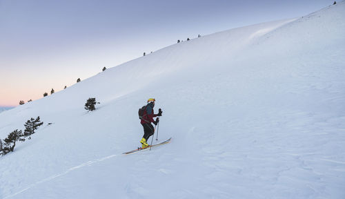 Mature man mountain climbing at pyrenees mountain during winter