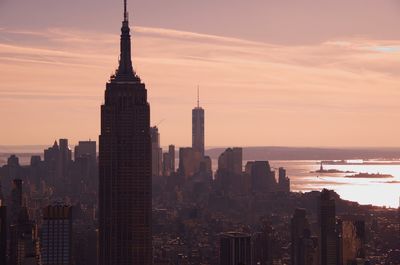 View of cityscape against cloudy sky