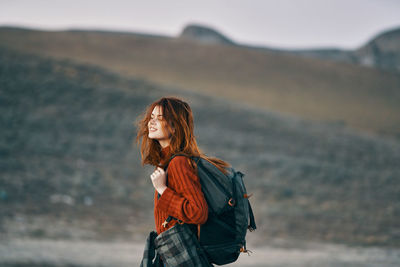 Midsection of woman standing at shore