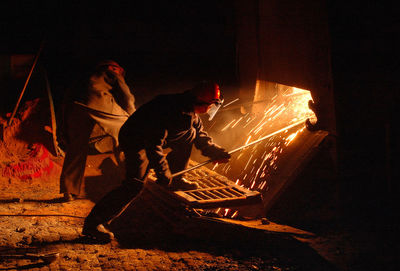 People working on illuminated stage