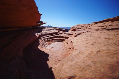 Low angle view of rock formation against clear sky