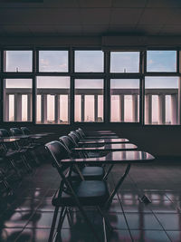 Empty chairs and tables in building