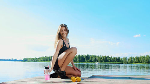 Beautiful, athletic young blond woman, coach, instructor, stretching, doing different exercises. 