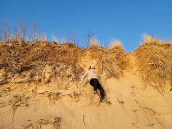 Dog jumping in a desert