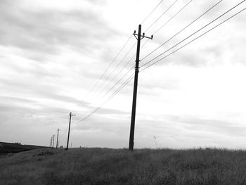 Low angle view of electricity pylon against sky