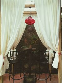 Red umbrella hanging on chair