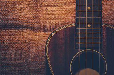 Close-up of guitar on burlap