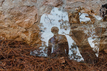 High angle view of man reflecting on glass