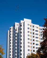 Low angle view of buildings against clear blue sky