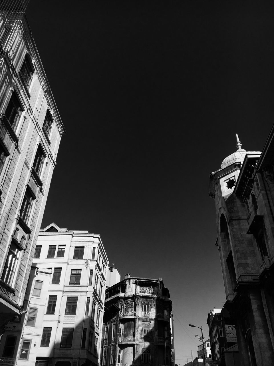 LOW ANGLE VIEW OF BUILDINGS AGAINST CLEAR SKY