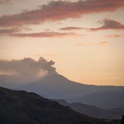 Scenic view of silhouette mountains against sky during sunset