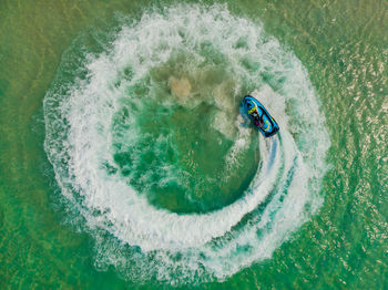 Directly above shot of man driving jet boat in sea