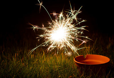 Firework display on field at night