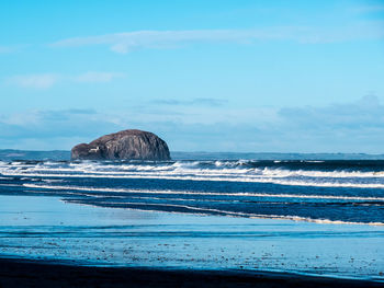 Scenic view of sea against blue sky