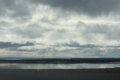 Scenic view of sea against storm clouds