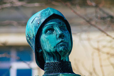 Close-up of statue against blue sky