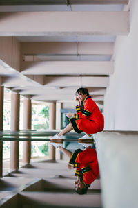 Woman sitting on wall