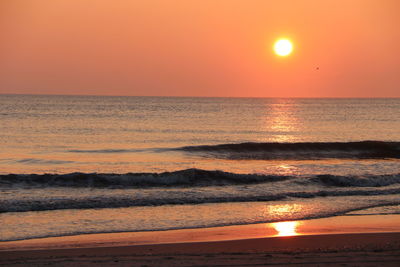 Scenic view of sea against romantic sky at sunset