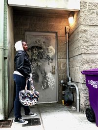 View of woman standing by building