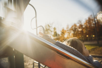 Rear view of woman relaxing against sky