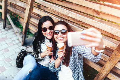 Portrait of smiling young woman using mobile phone