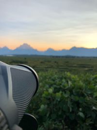 Scenic view of land against sky during sunset