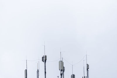 Low angle view of communications tower against sky