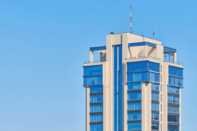 Low angle view of building against clear blue sky