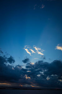 Low angle view of sea against dramatic sky