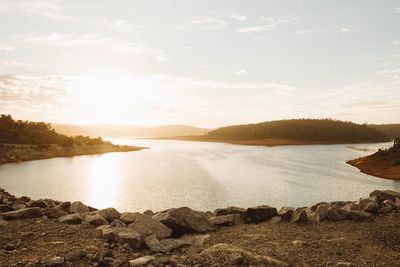 Scenic view of lake against sky during sunset