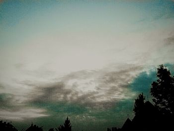 Silhouette of tree against cloudy sky