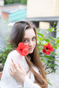 Portrait of woman with red flower