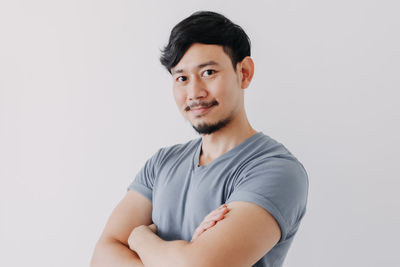 Portrait of young man against white background