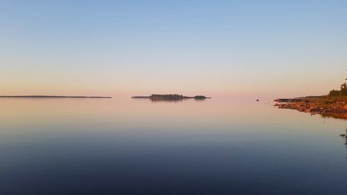 Scenic view of sea against clear sky during sunset